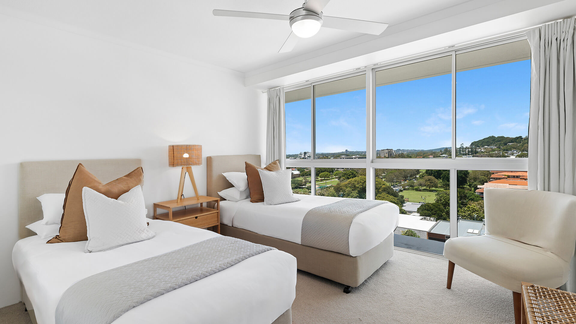 Twin bedroom in the 2 Bedroom Pool View Apartment at ULTIQA Points North with large windows and scenic views.