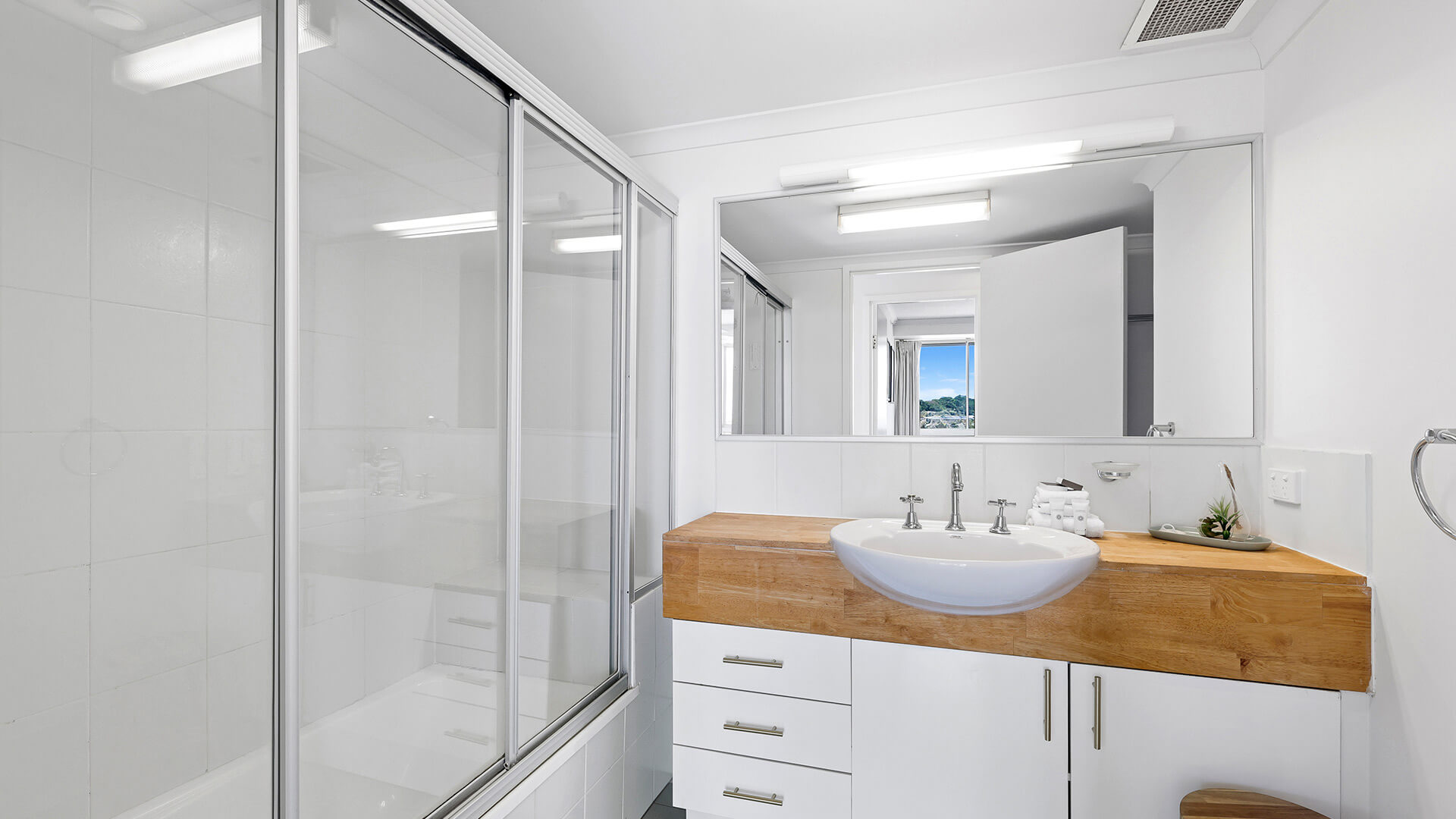 Bathroom in the 2 Bedroom Pool View Apartment at ULTIQA Points North with shower over bath and modern vanity.