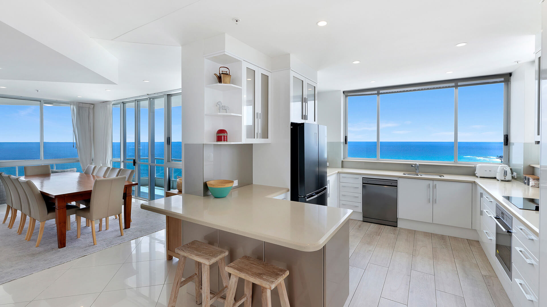 Modern kitchen and dining area of the 4 Bedroom Oceanfront Penthouse at ULTIQA Points North with ocean views.