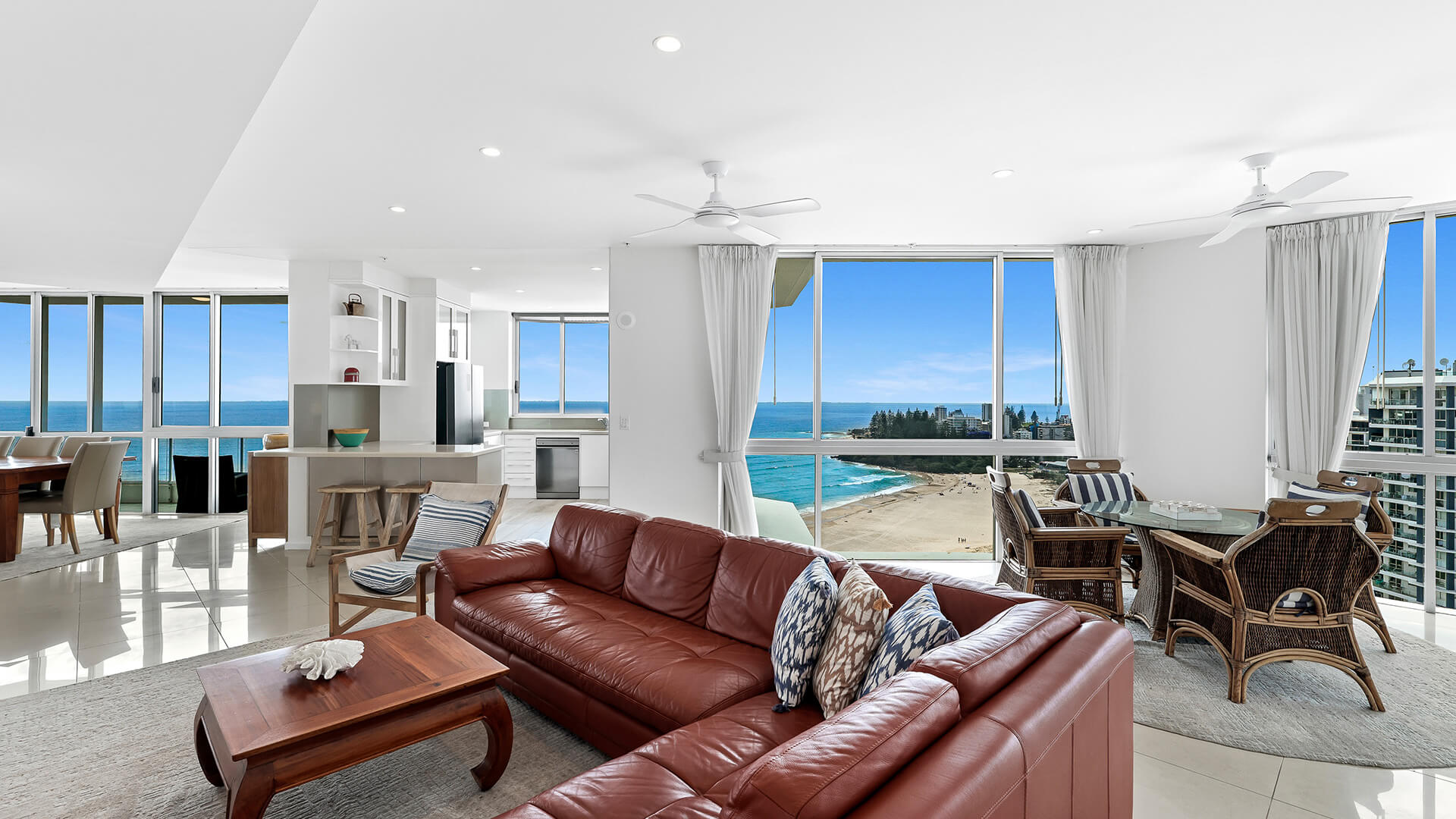 Spacious living and dining area of the 4 Bedroom Oceanfront Penthouse at ULTIQA Points North with sweeping ocean views.