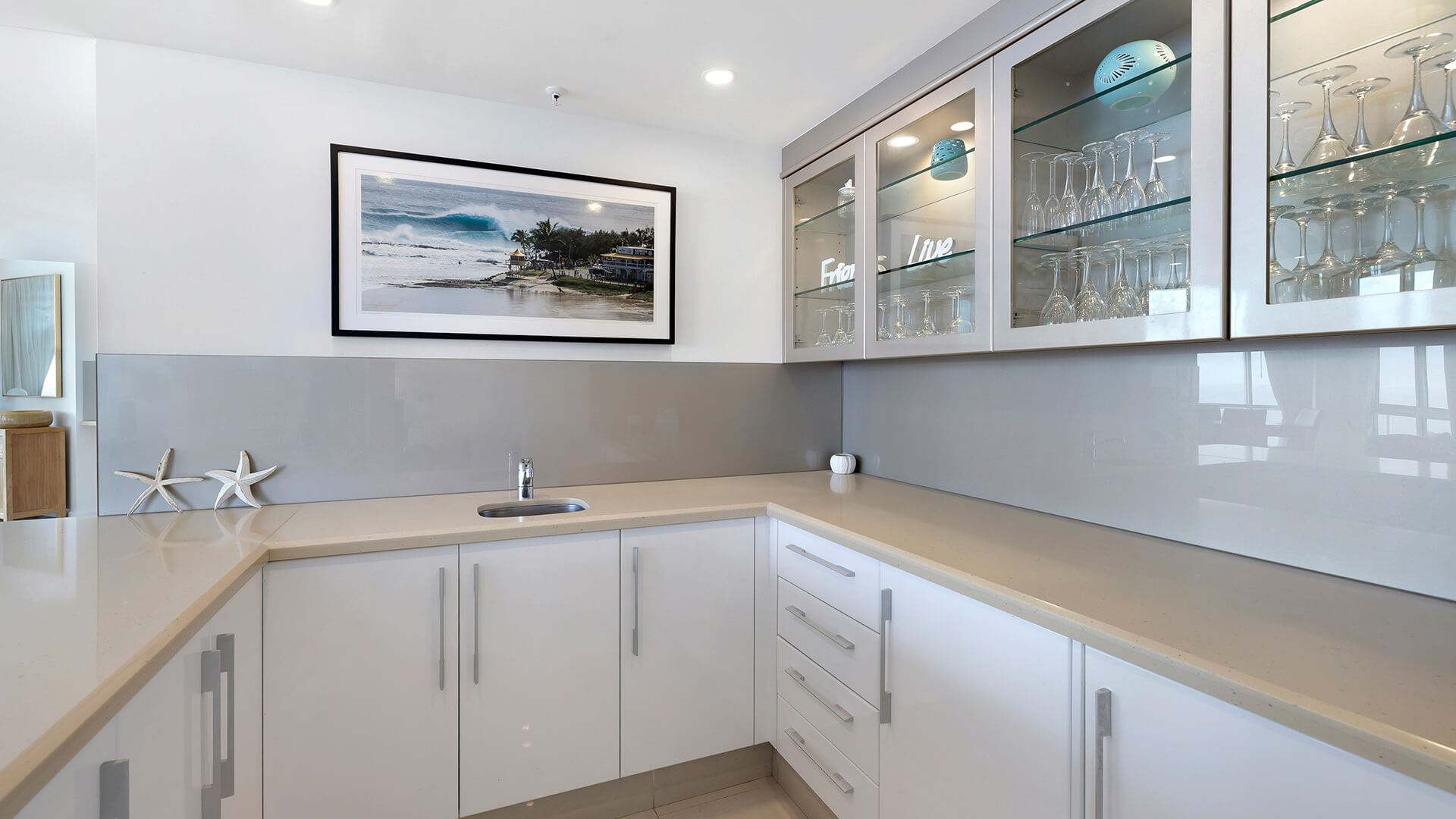 Bar area of the 4 Bedroom Oceanfront Penthouse at ULTIQA Points North with glass cabinetry and bench space.