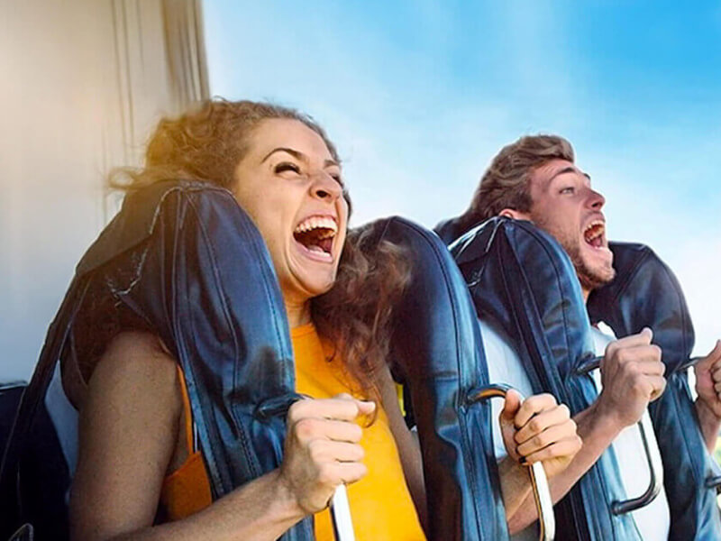Excited riders screaming with joy on a high-speed theme park ride at the Gold Coast.
