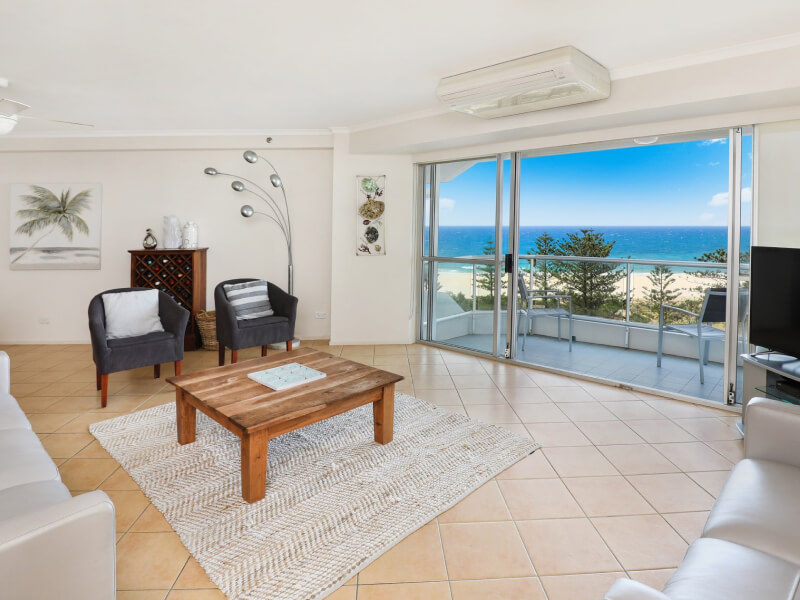 Spacious living area at ULTIQA Points North with ocean views from the balcony.