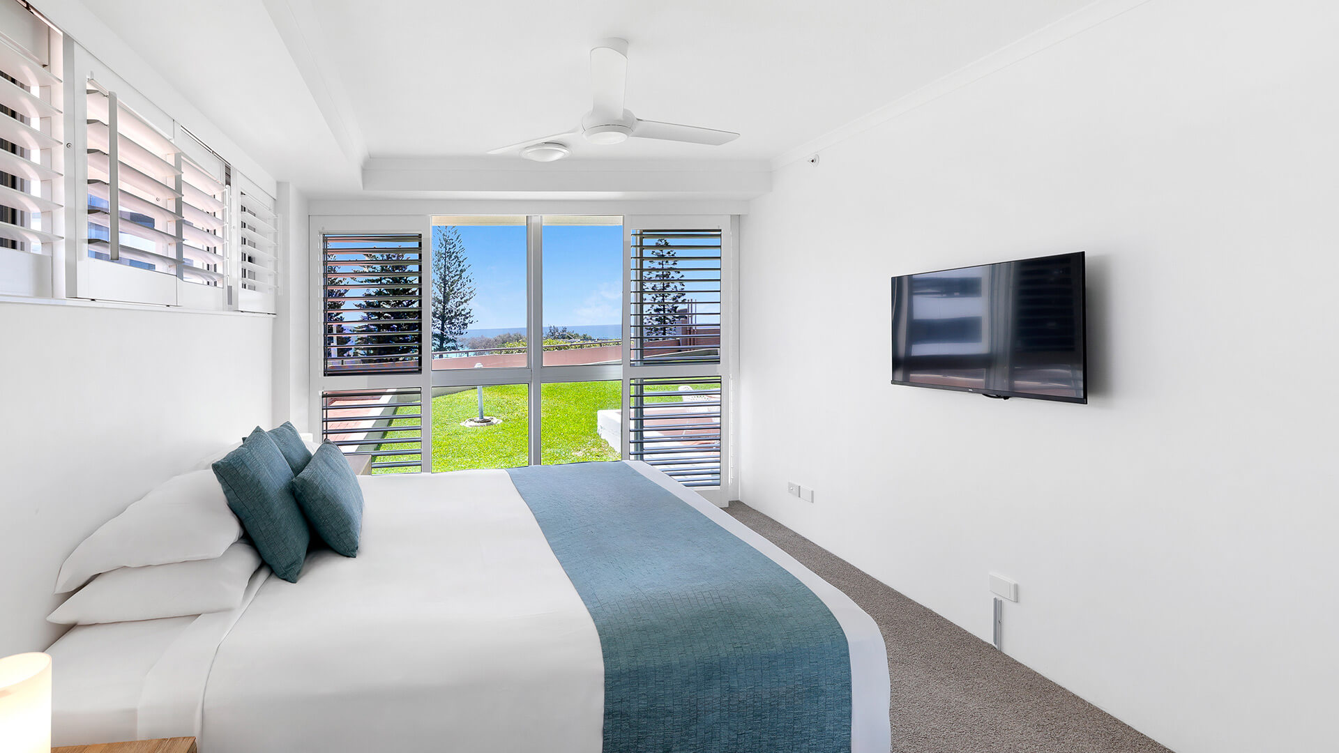 Master bedroom in the Superior 2 Bedroom Courtyard Apartment at ULTIQA Points North, with direct access to the courtyard and ocean glimpses.
