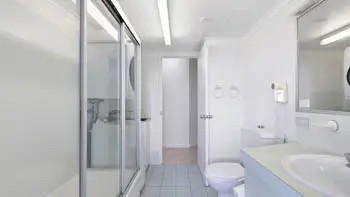 Bathroom and laundry area in the Standard 2 Bedroom Ocean View Apartment at ULTIQA Points North, featuring a shower and vanity.