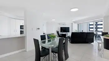 Modern white kitchen in the 2 Bedroom Superior Ocean View Apartment featuring ample cabinetry, tiled floors, and full appliances.