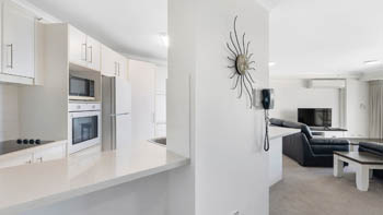 Kitchen and living area in the Superior 1 Bedroom Ocean View Apartment at ULTIQA Points North.