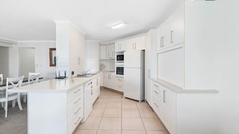 Modern spacious kitchen and dining area in the Superior 1 Bedroom Ocean View Apartment at ULTIQA Points North.